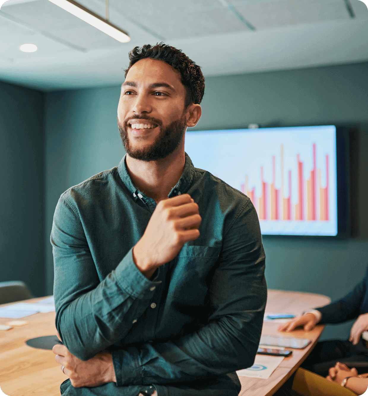 Confident young man smiling during a business meeting.