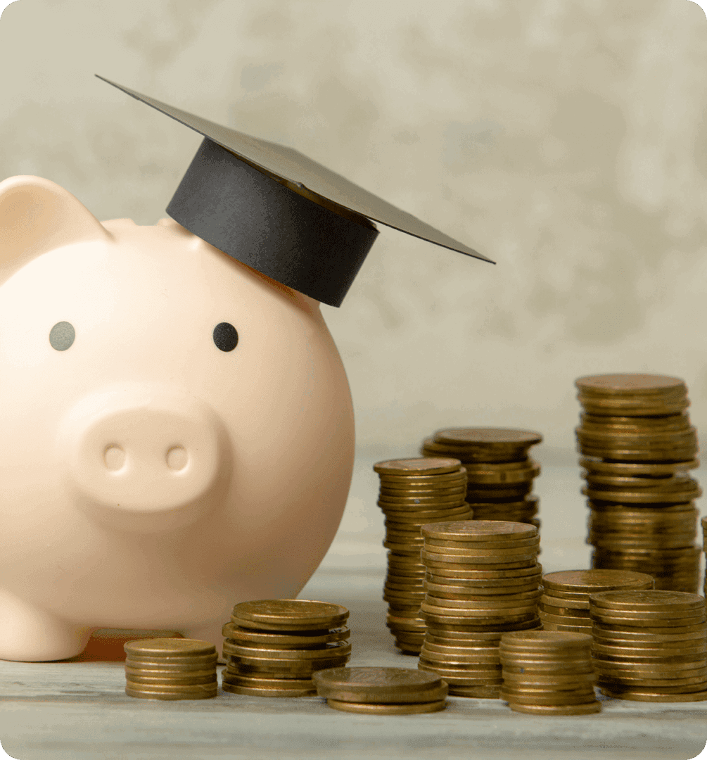 Piggy bank wearing a graduation cap with stacked coins.